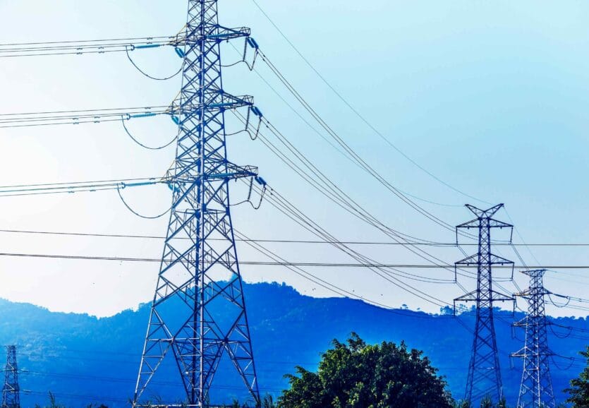 electricity-transmission-pylon-silhouetted-against-blue-sky-d-2-scaled