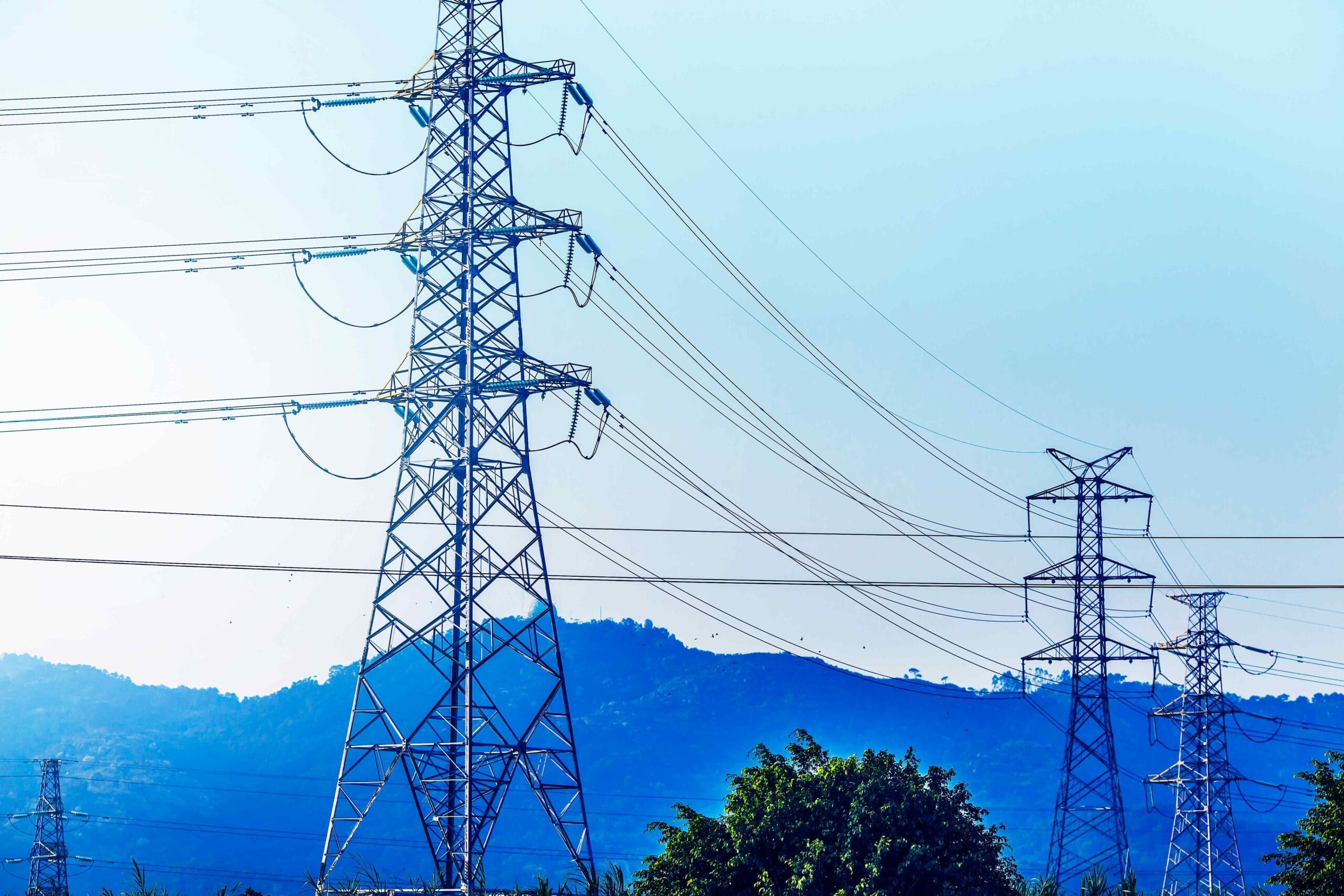 electricity-transmission-pylon-silhouetted-against-blue-sky-d-2-scaled